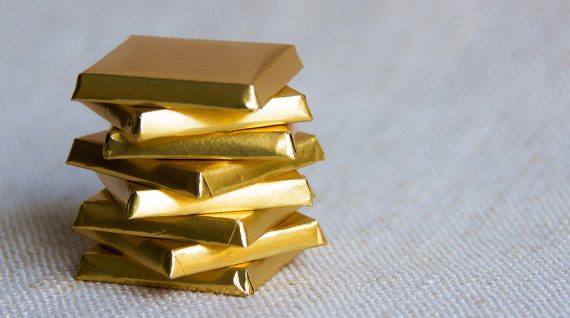 Chocolate bar squares wrapped in a golden paper