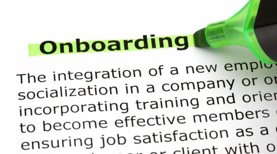 Dictionary definition of the word Onboarding highlighted with green marker pen.