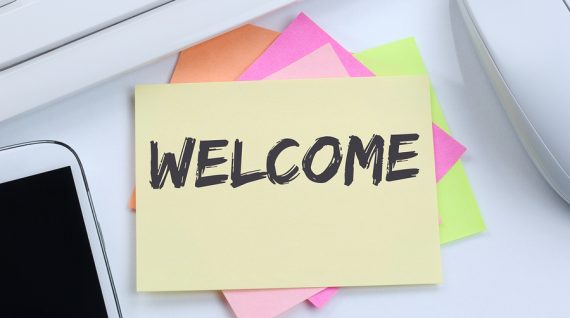 Welcome new employee colleague refugees refugee immigrants desk computer keyboard