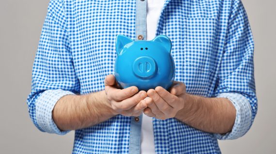 Man holding piggy bank, closeup