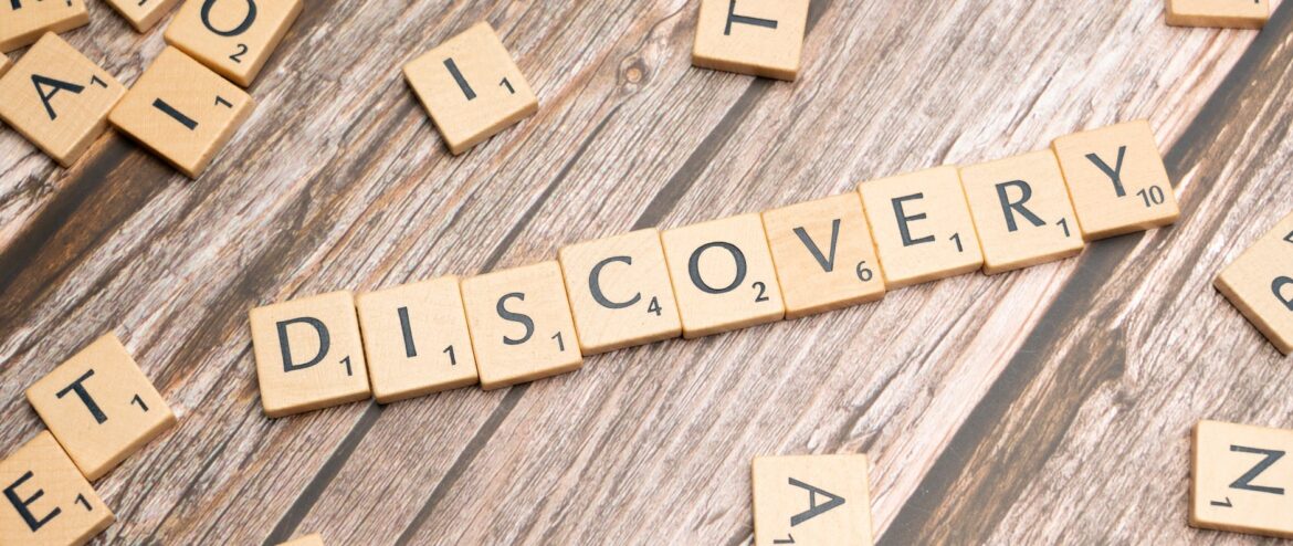 the word discovery spelled out in scrabble letters